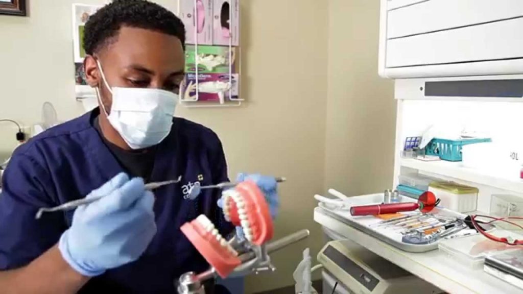 picture of dentures and dental assistant